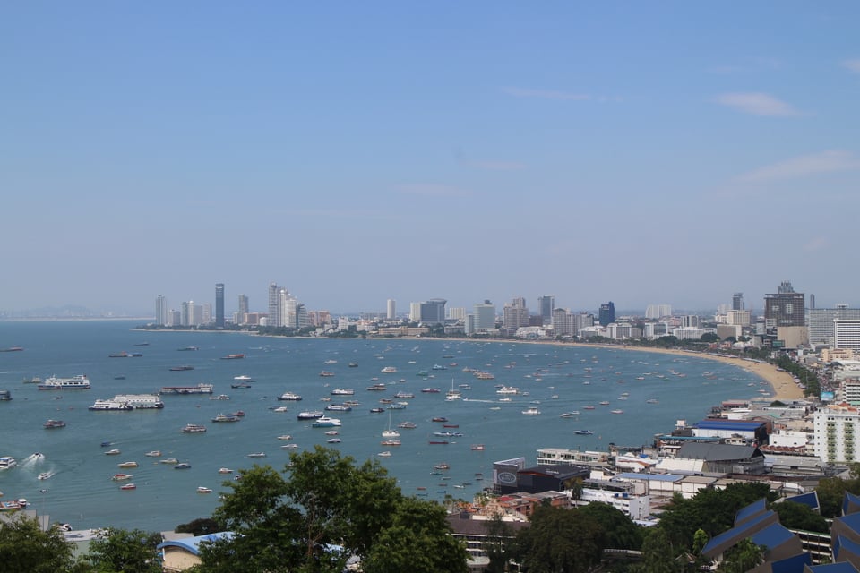 Pattaya Bay and its city skyline viewed from Phra Tamnak Hill in 2024.